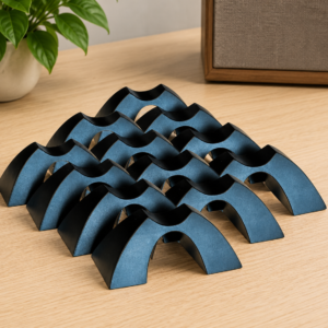 Twelve Cable Arch speaker cable elevators arranged on a light wood surface for consistent cable routing and spacing.